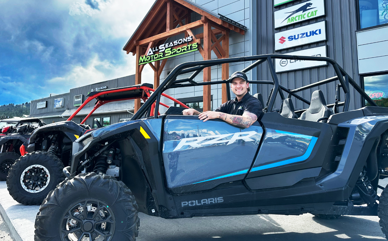 General Manager of All Seasons Motorsports in a quad in front of the building.
