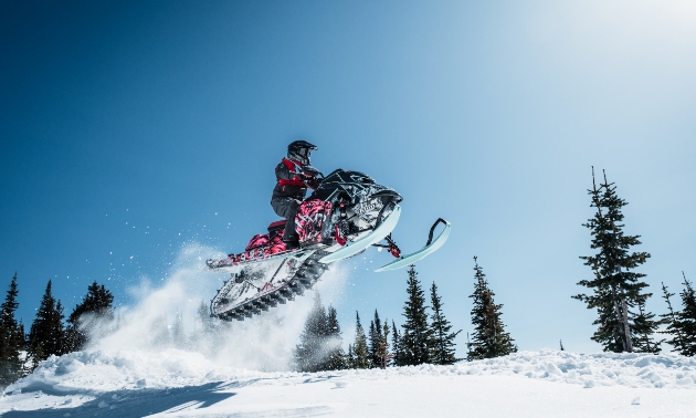 Amber Heberling taking a jump on her sled