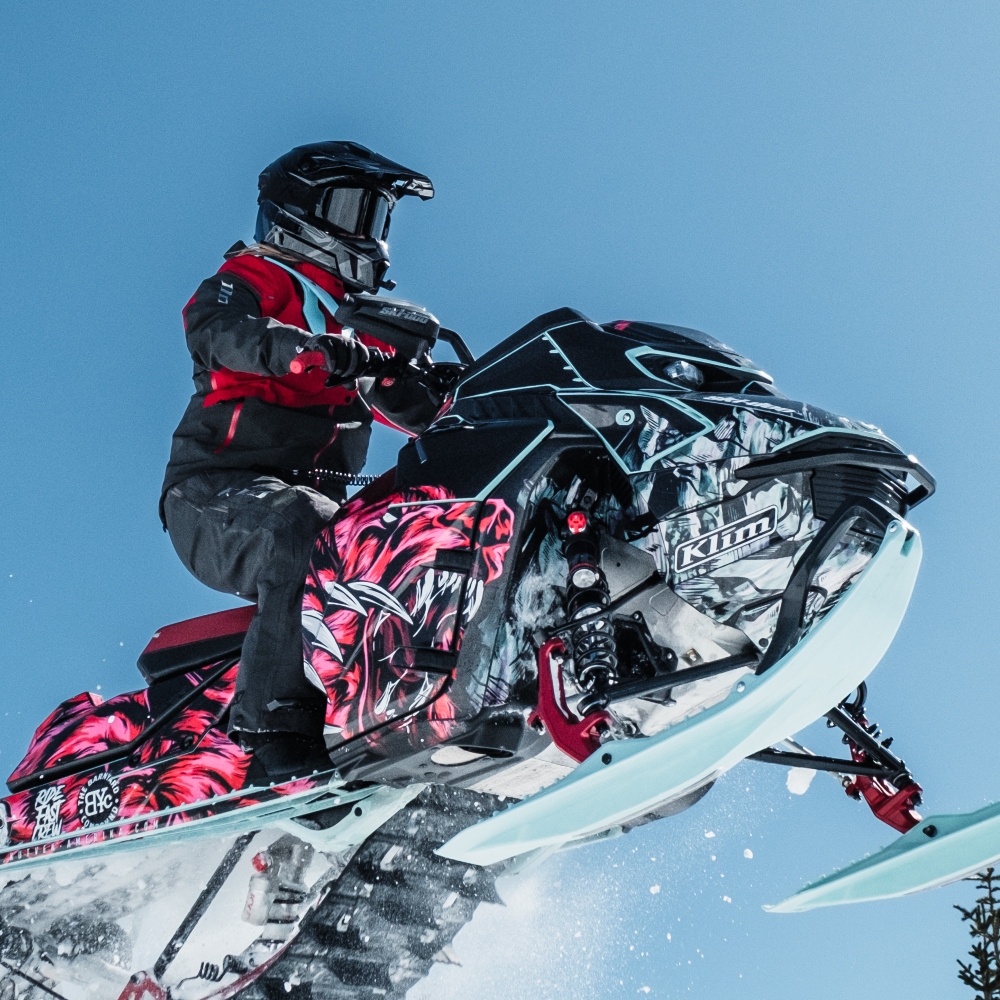 Amber Heberling taking a jump on her sled