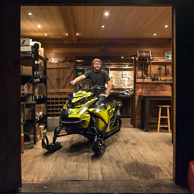 Andrew Munster on his sled in a shop. 