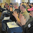 A group of people putting their hands up. 