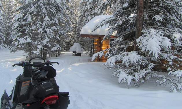 “The Cabin” under a large dump of new powder snow, on the South West end of the Bilsky Loop, about 7km off of the Trans Canada Snowmobile Trail.     