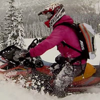 A woman on a yellow sled with an ABS airbag pack. 