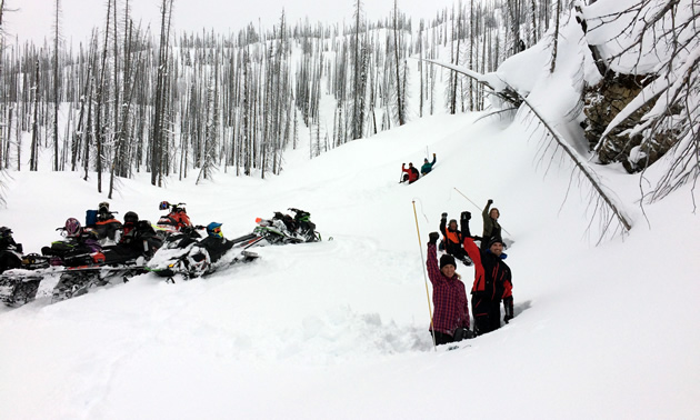 A group of AST students digging a snow pit. 
