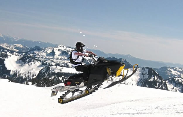 Photo of a snowmobile taking a jump