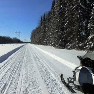 Picture of snowmobiler on straight trail.