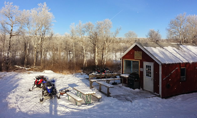 Sleds parked outside a snowmobile cabin near Birch Hills, Saskatchewan. 