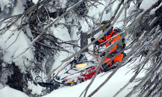 Snowmobiler in an orange Blitzkrieg monosuit from Motorfist. 