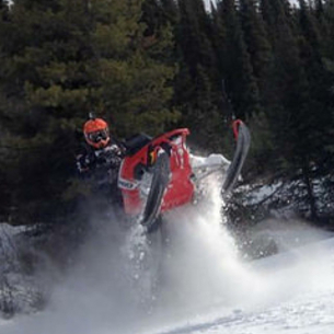 Blair Trueman is airing out his sled in Blue River forested terrain.