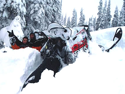 People sitting on snowmobiles