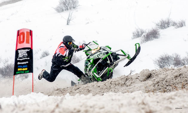 Bent Pukas dangles off his sled in a hillclimb race for RMSHA. 