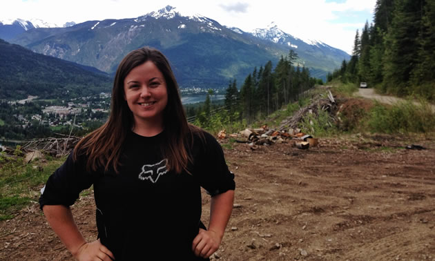 Brianna Lukkar poses for a head and shoulders photo with Revelstoke in the background. 