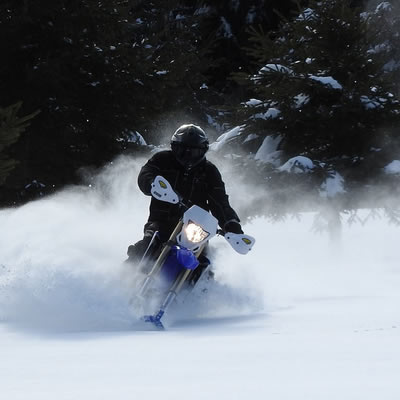 The Camso dirt-to-snow bike conversion system allows riders to switch the front wheel of their off-road motorcycle with a ski and the rear drive systems with a tracked undercarriage. 