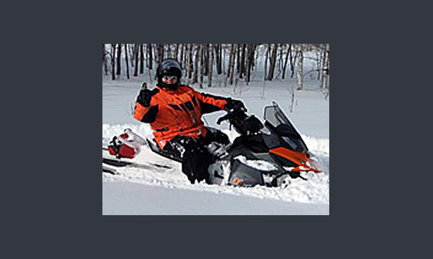 Chris Brewer President/CEO riding snowmobile
