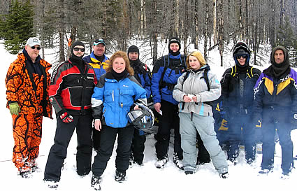 People standing together wearing snowmobile gear