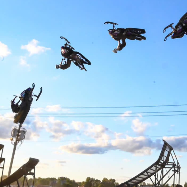 Chris riding his sled in a flip over a jump