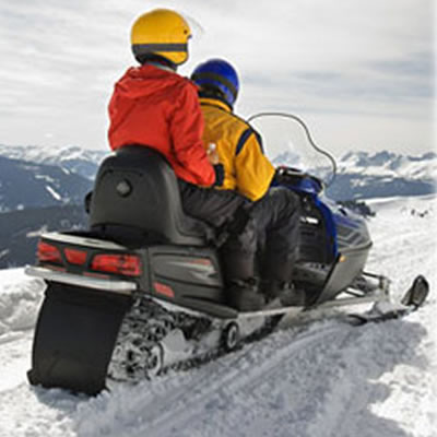 Couple riding on a snowmobile.