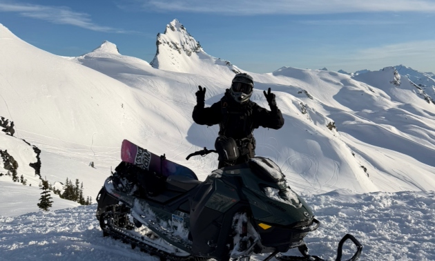 Craig McMorris giving thumbs up while on his snowmobile