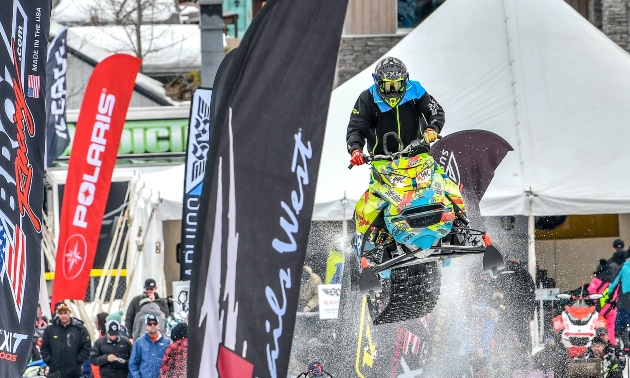 Daine riding a sled over a jump at an event