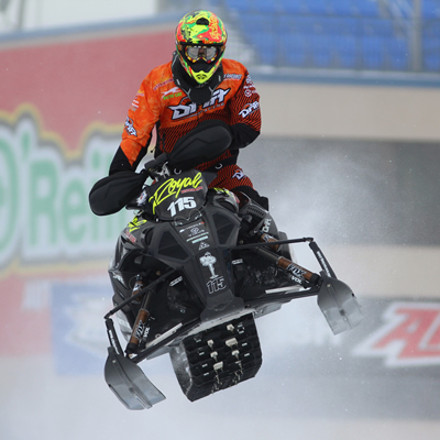 David Joanis snocross racer flies through the air in a race. 