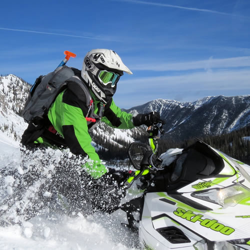 a snowmobiler blasting through fresh in Fernie. 