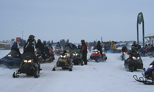 people getting on their snowmobiles