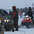 people getting on their snowmobiles