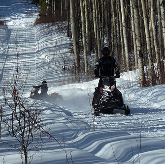 Two riders on the trail near the Muffaloose firepit on Stoney mountain at the 2015 poker rally