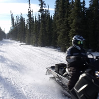 A snowmobiler riding along a trail in Central Alberta. 