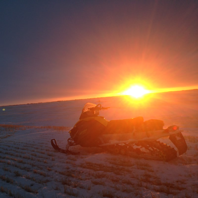 Snowmobile in the sunset in Saskatchewan. 