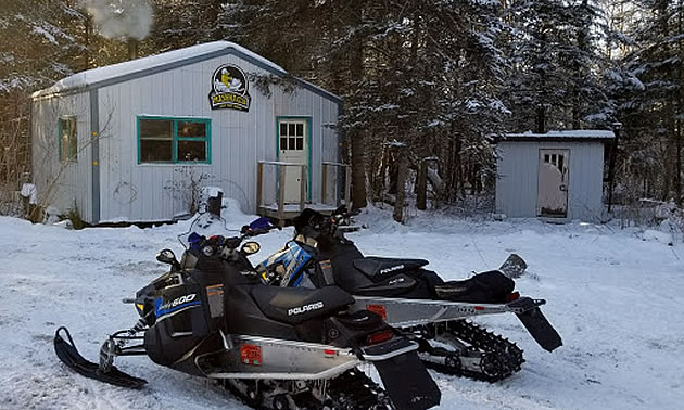 Two sleds parked outside a warm up shelters near Powerview-Pine Falls. 