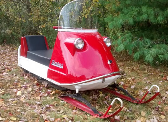Picture of restored red Herters snowmobile. 