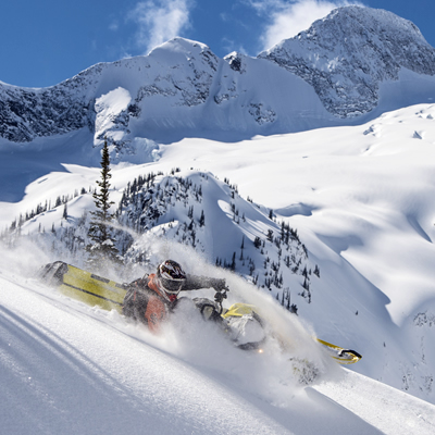 Jeremy Hanke carves a line with stunning mountain terrain in the background. 