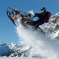 A man soaring through the air on a white sled. 