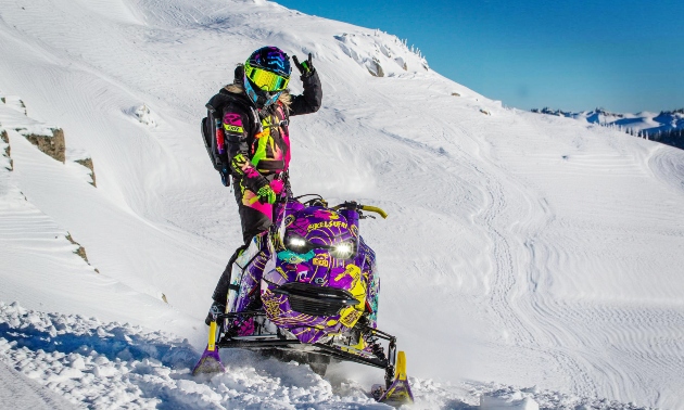 Kelsey waving beside her sled
