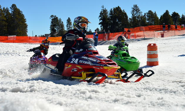 Kids racing snocross on 120-cc snowmobiles in West Yellowstone. 