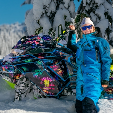 Kylee standing next to her sled in a snowy location