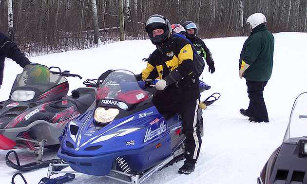 people on snowmobiles