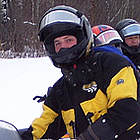 people on snowmobiles
