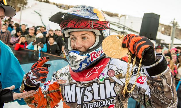 Levi LeValle holding up a gold medal from the Winter X Games. 