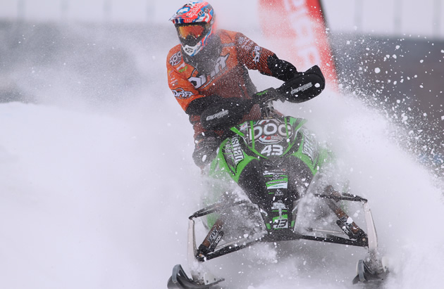 Logan Christian snocross racer powers through a corner in a race. 