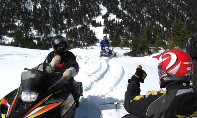 Friends enjoy snowmobiling in Mackenzie.
