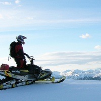 A snowmobiler admires the view from on top of Morfee Mountain near Mackenzie, BC.