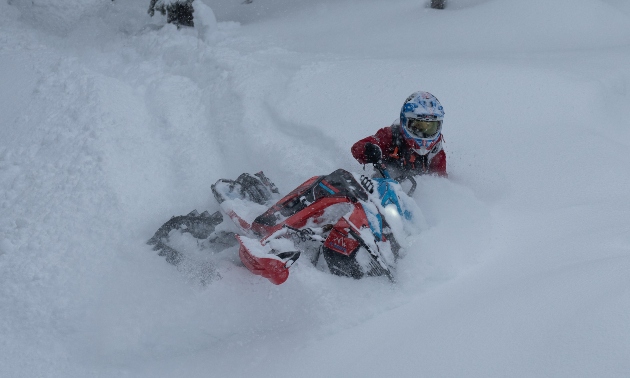 Marshall sledding through powder