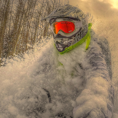 A rider flying through deep snow with a Nekkr on. 