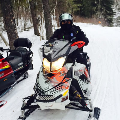A picture of Derek Silversides, enjoying his first snowmobile ride. 