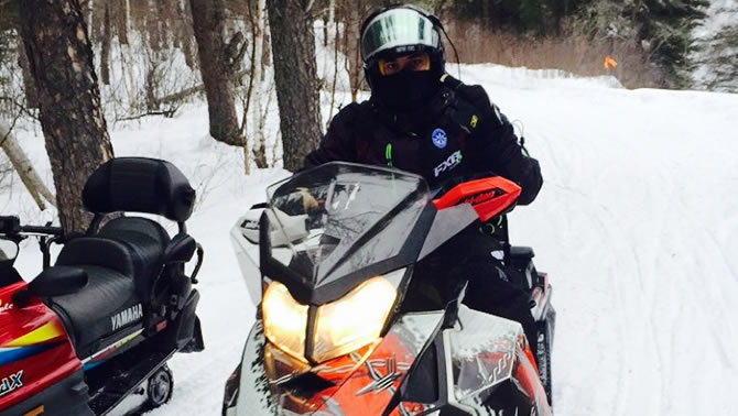 A picture of Derek Silversides, enjoying his first snowmobile ride. 
