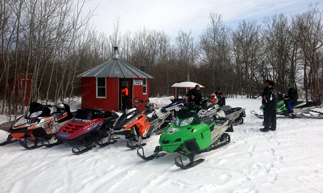 Snowmobilers parked at the Barley Bin warm up shelter. 