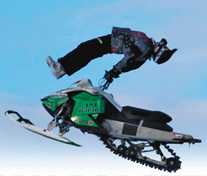 Person doing a trick on a snowmobile