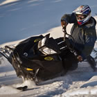 Photo of a guy sidehilling with a black sled. 